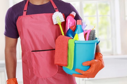 Technician using carpet cleaning equipment in a home with safety precautions
